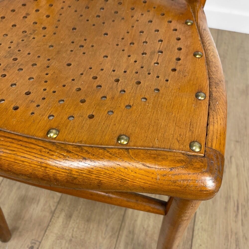 Pair of curved wood bistro chairs and studded and perforated seat