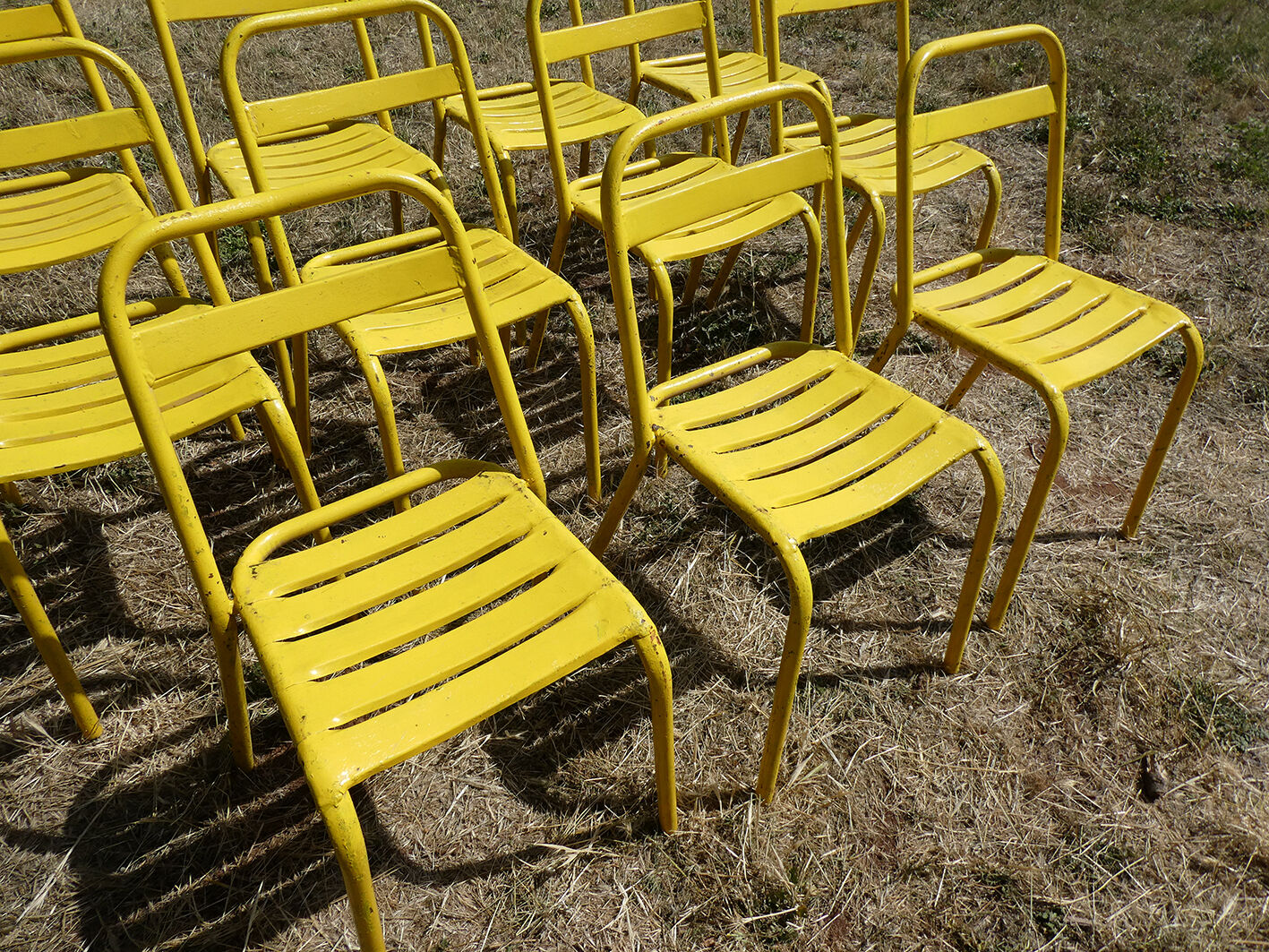 Lot of 11 yellow metallic bistro chairs from the 1950s
