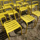Lot of 11 yellow metallic bistro chairs from the 1950s