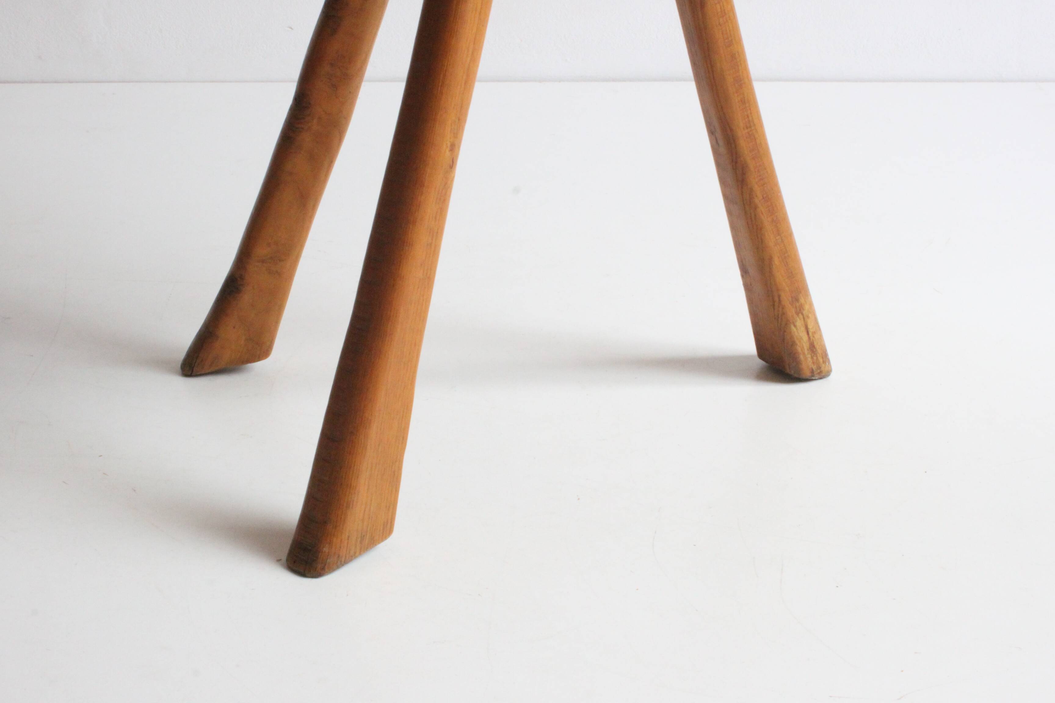 Brutalist tripod stool in carved wood, 1950s
