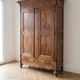 Large antique wooden wardrobe with drawer.