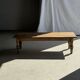 Brown Indonesian teak coffee table, with a border and cylindrical legs H40 L103.