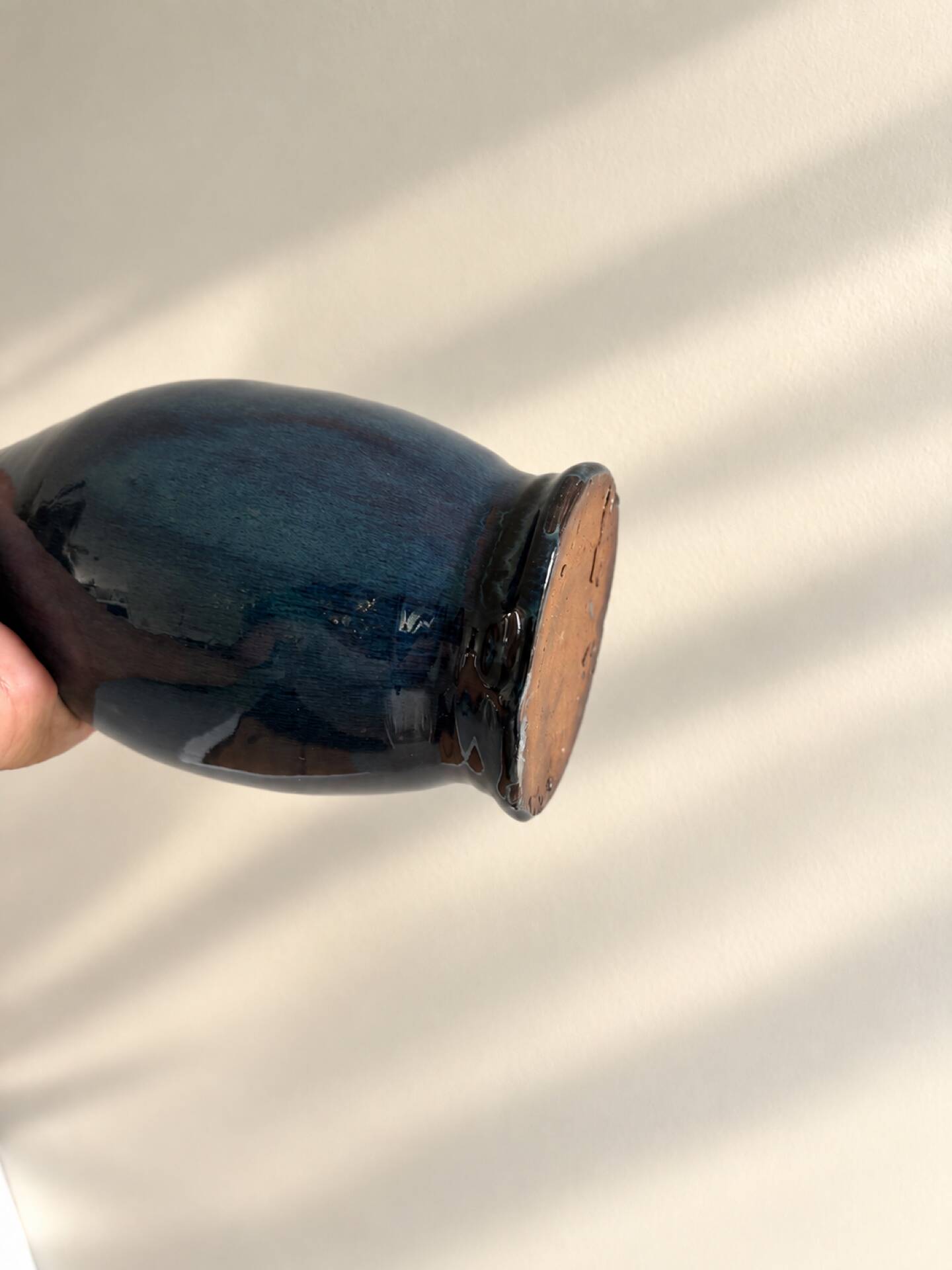 Decorative deep blue glazed ceramic vase with twin handles.