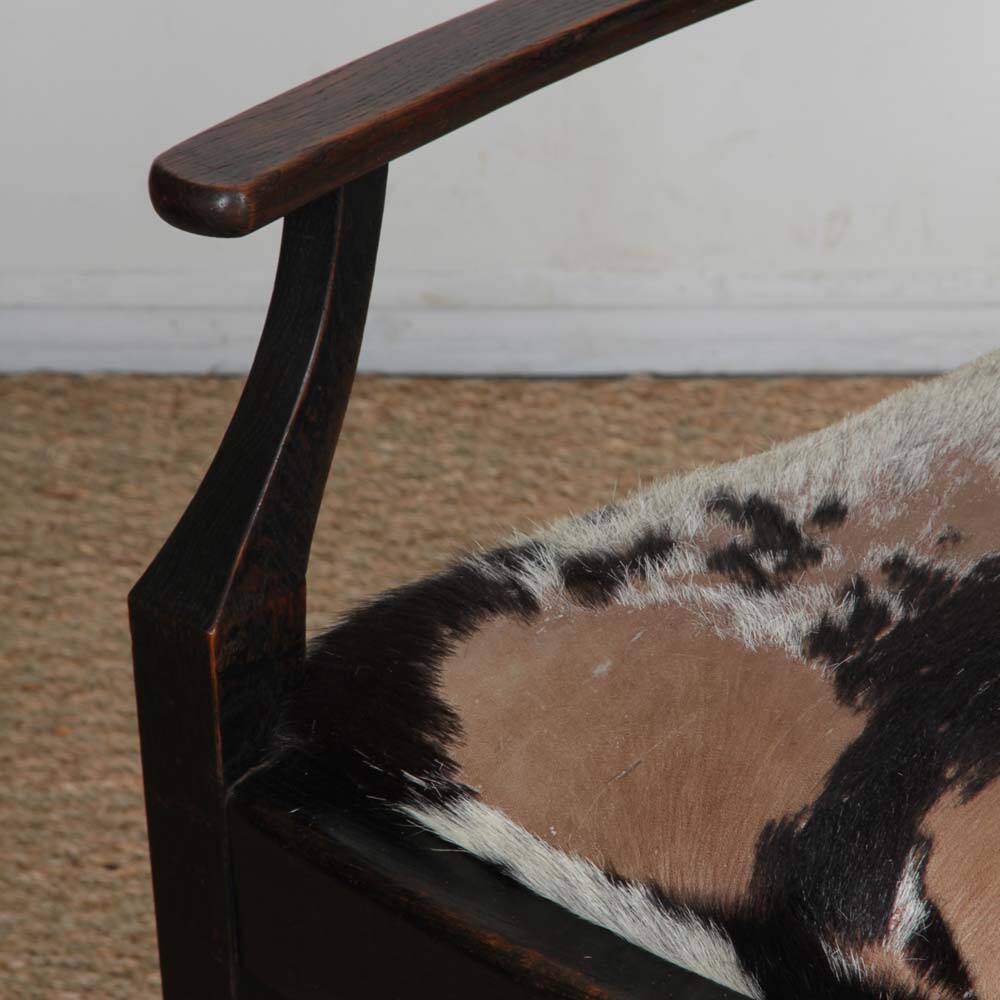 Bridge armchair in wood and leather, work from the early 20th century.