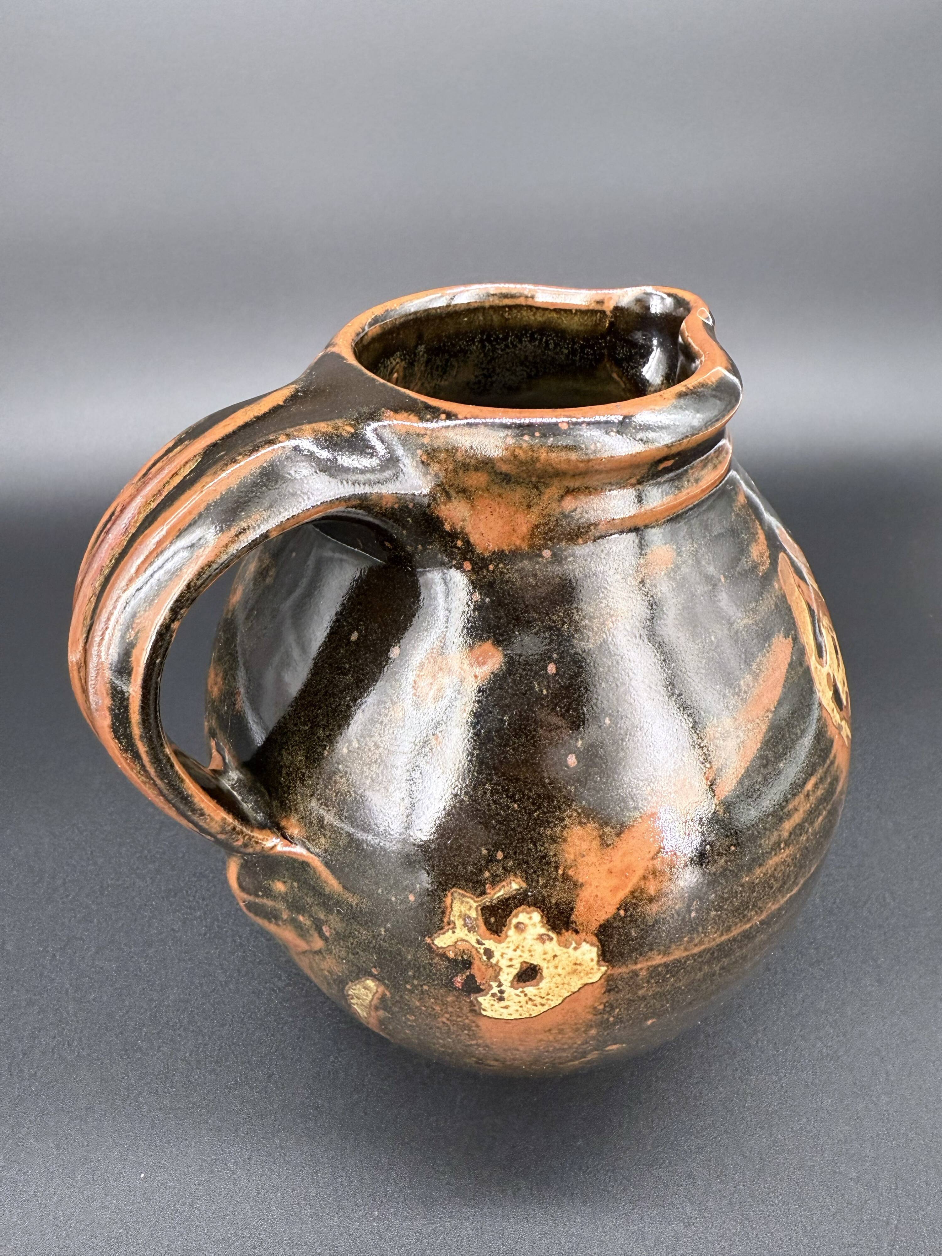 Signed black and red glazed stoneware pitcher, French artisanal ceramics