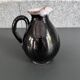 Antique black pitcher with white collar