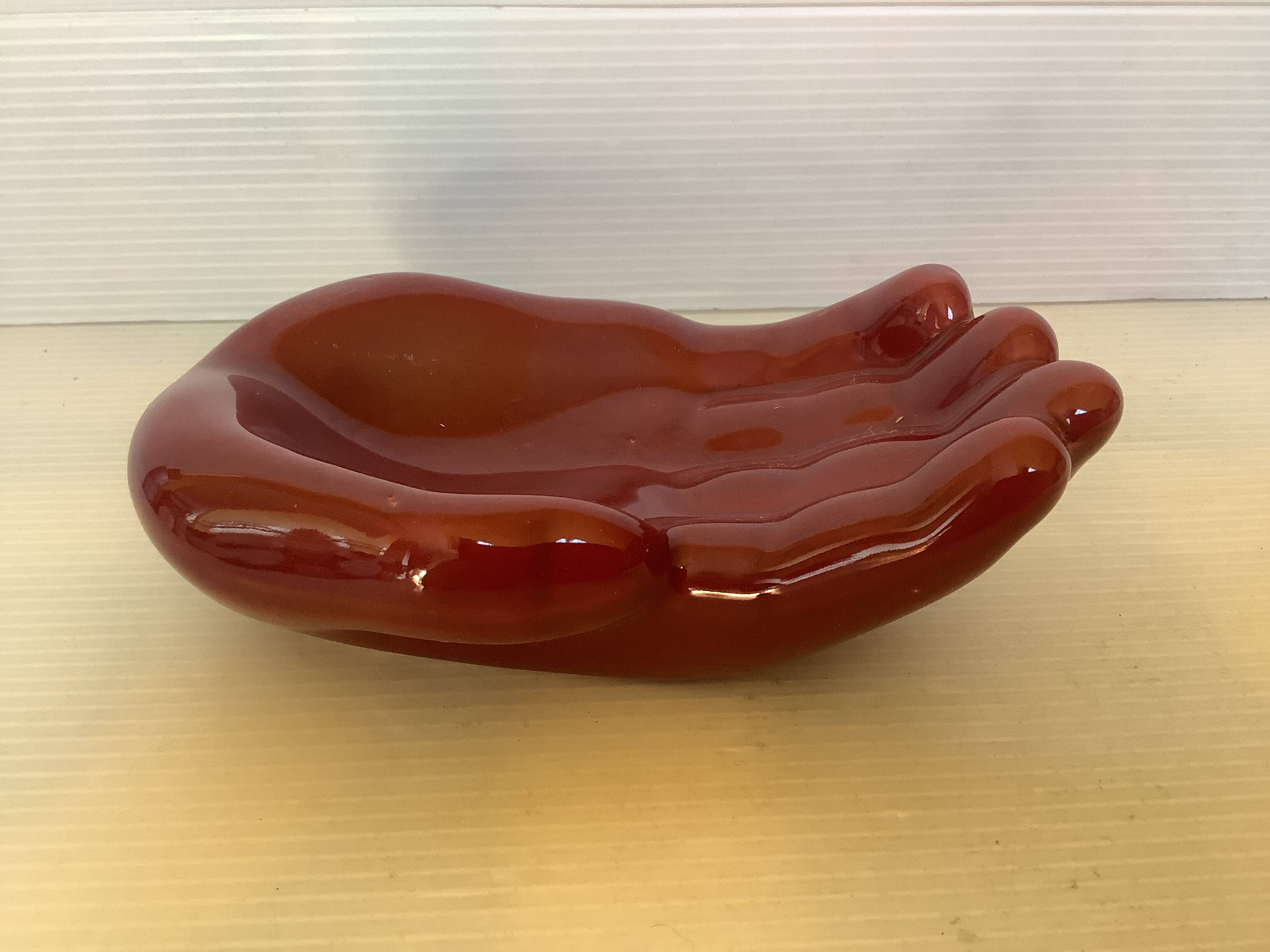 Empty pocket in the shape of a burgundy hand