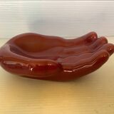 Empty pocket in the shape of a burgundy hand