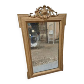 19th-century mirror in gilded wood and stucco.
