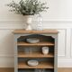 Green-grey library, wooden shelf and shelves in natural wood.