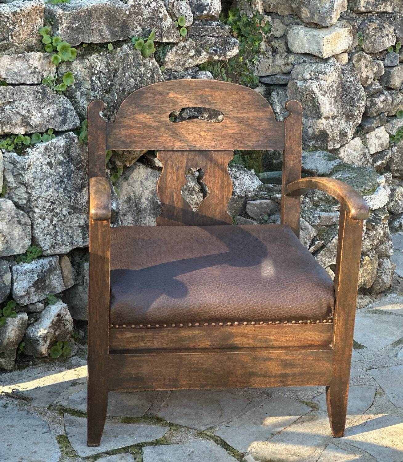 Pair of armchairs in stained wood and leather, 20th century