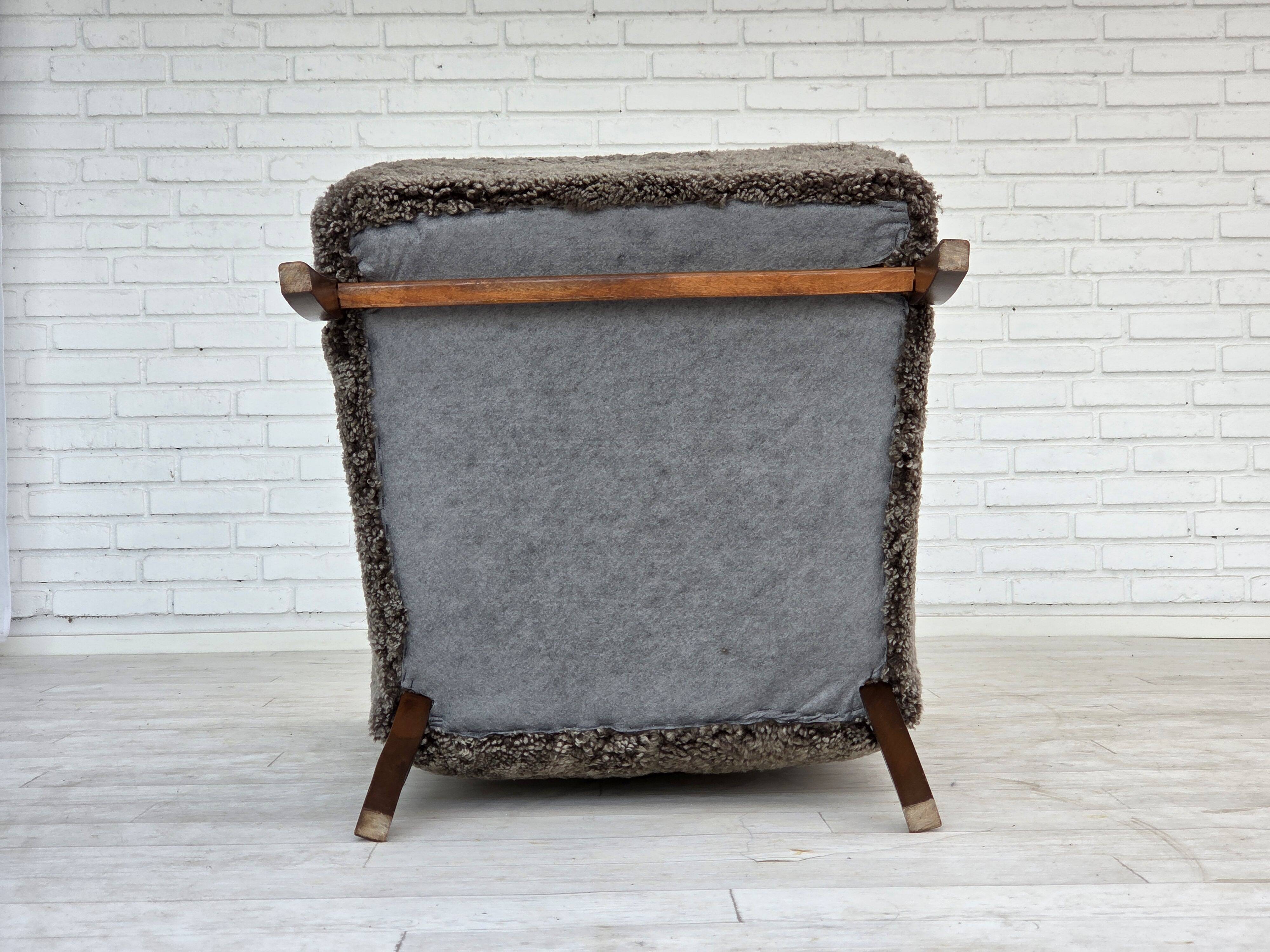 1960s, reupholstered Danish armchair, with stool, genuine sheepskin.