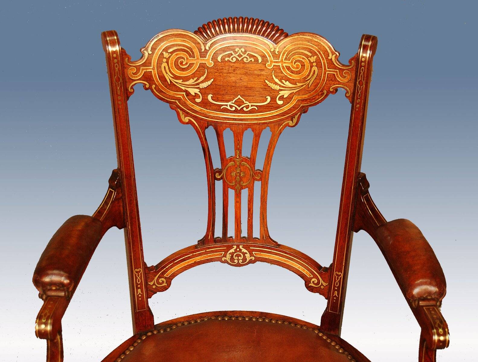 19th century armchair in leather and rosewood inlaid with brass and rosewood