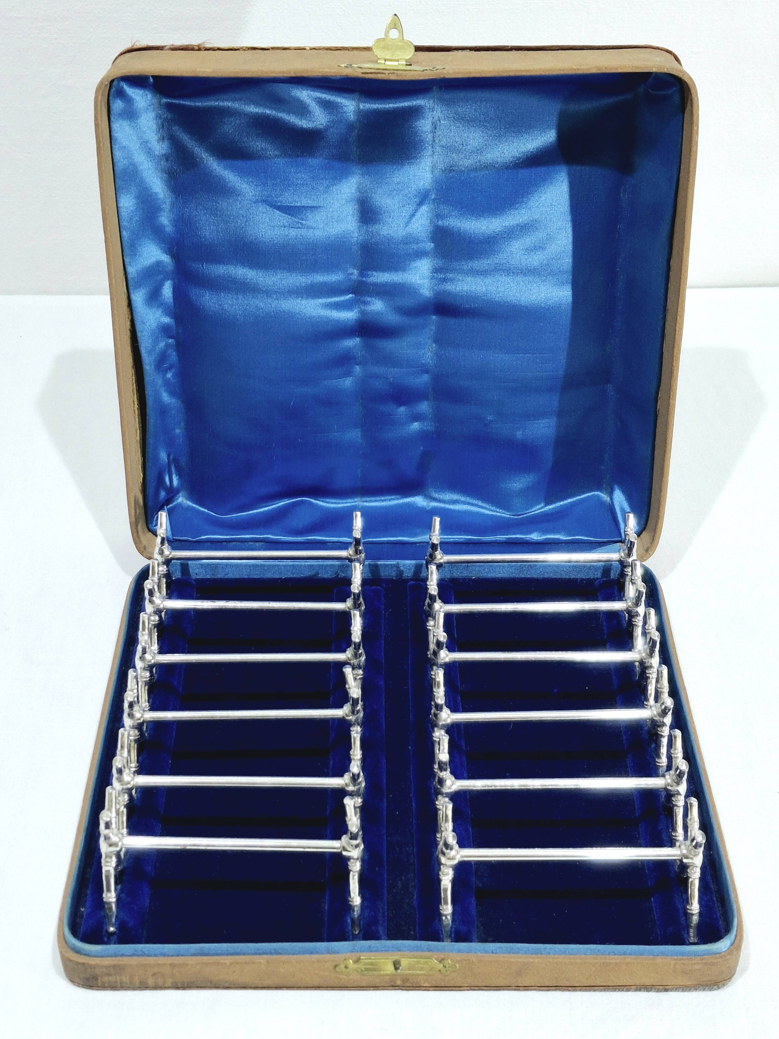 12 silver-plated metal knife handles, in a case.