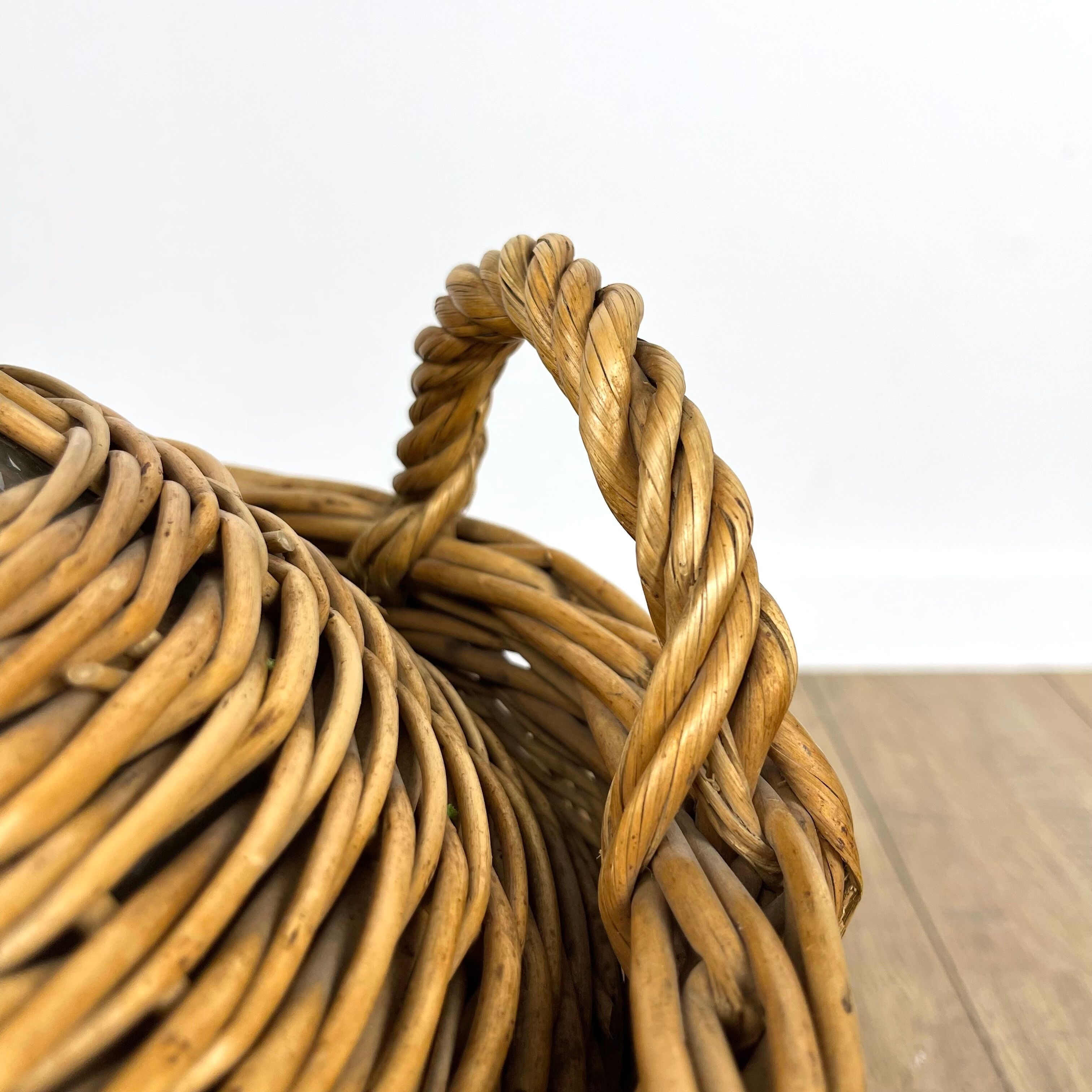Old demijohn in her wicker basket