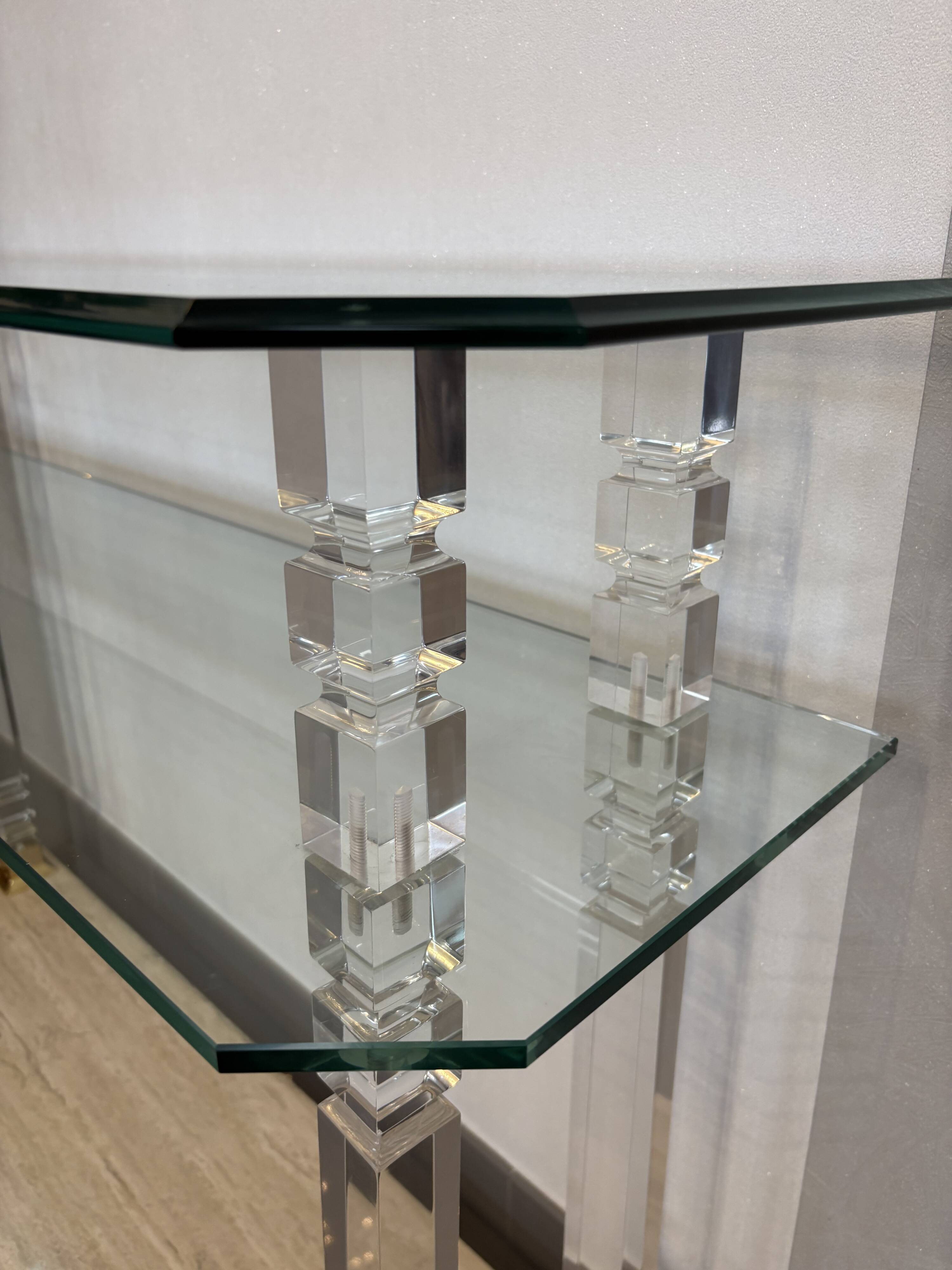 Hollywood Regency console style in travertine, glass, and Lucite.