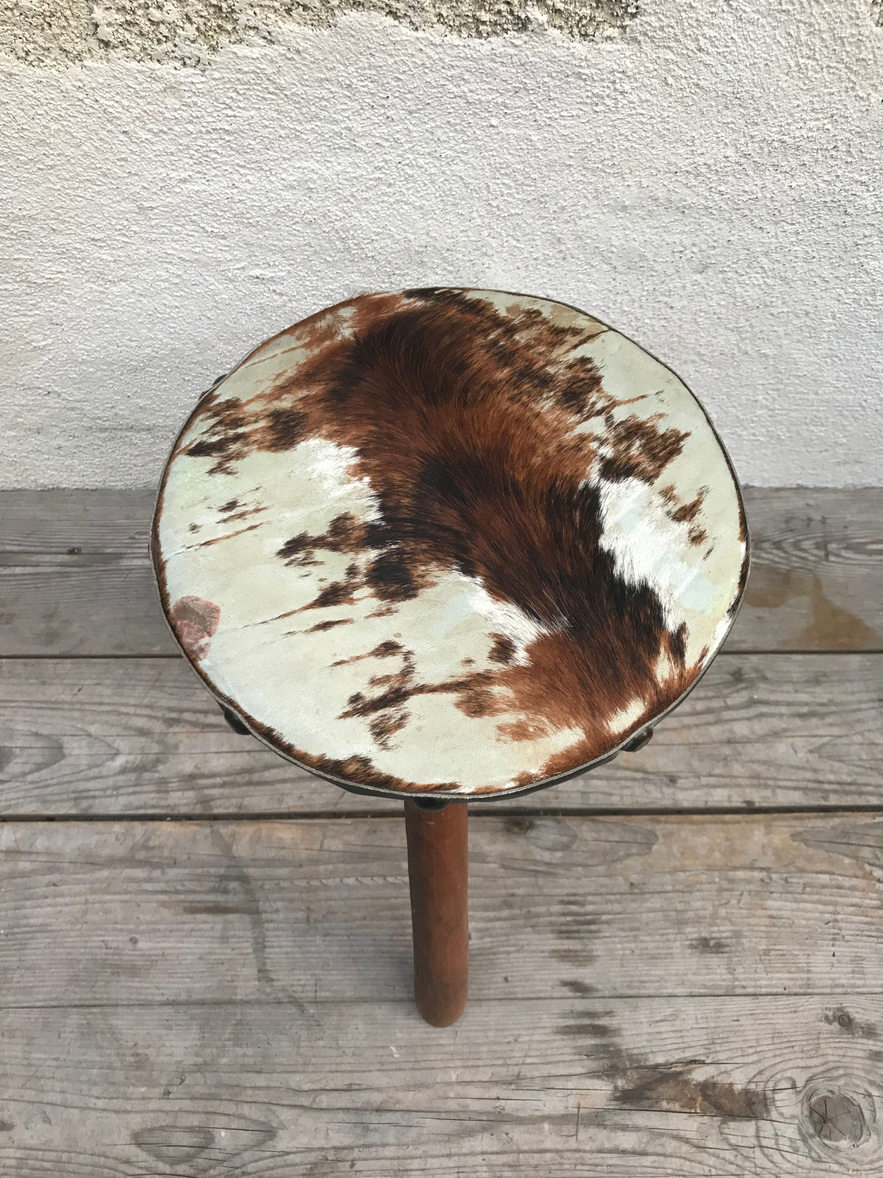 Old wooden tripod stool with seat leather vintage