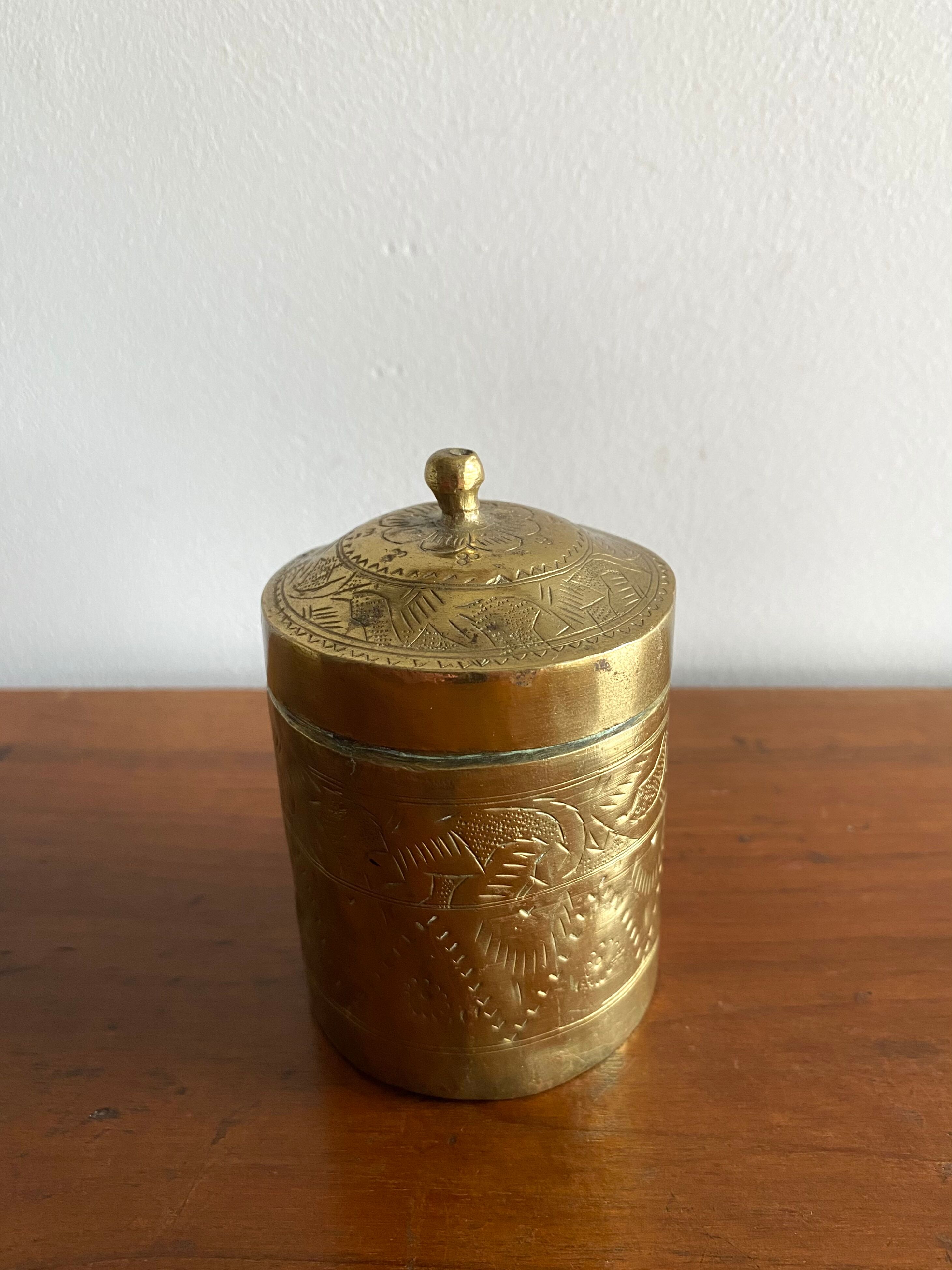 Old round box in chiseled brass