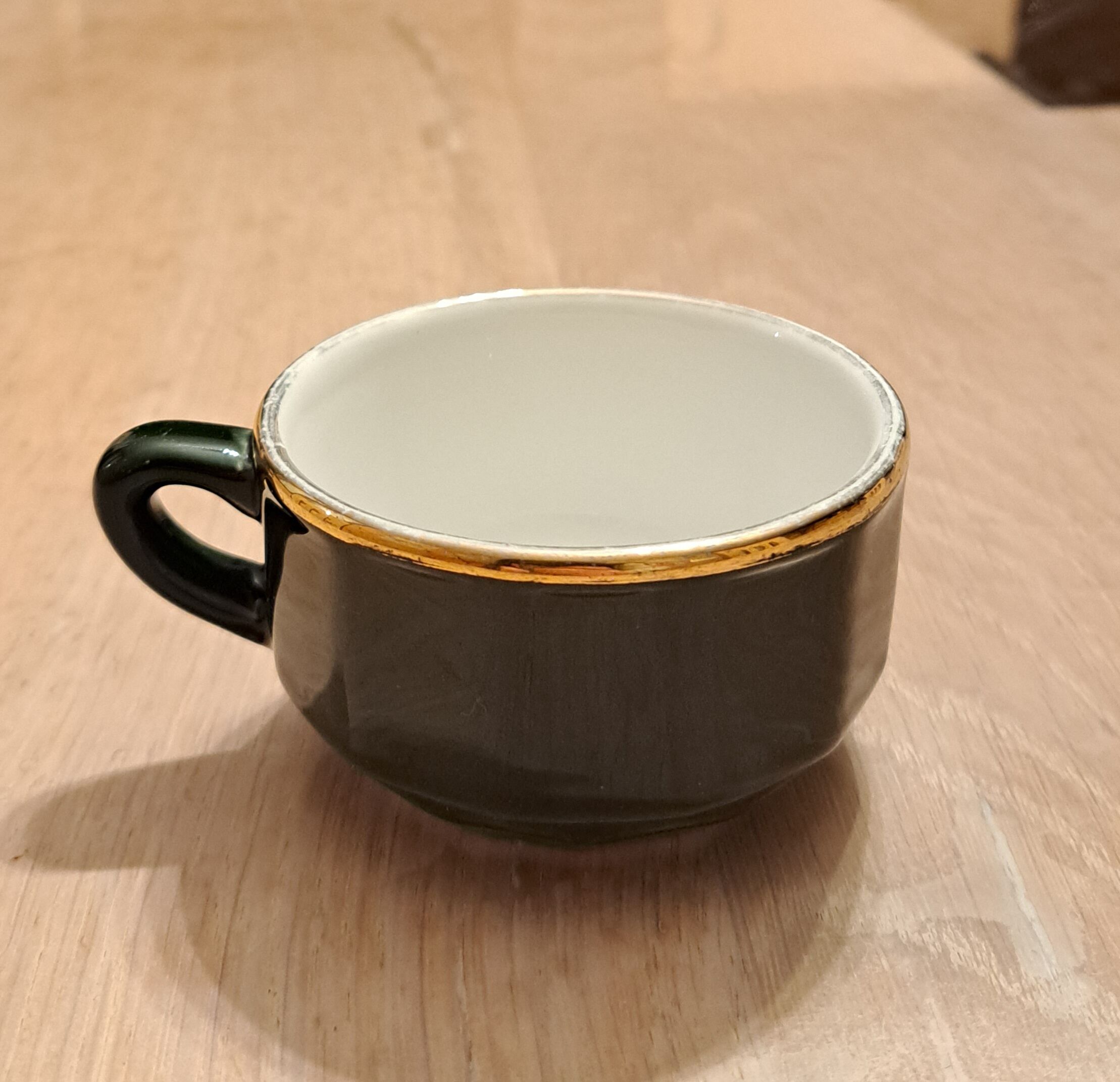 Green and gold coffee cups and sub-cups