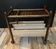 Vintage rattan magazine rack on wheels