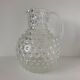 Beautiful and large vintage glass jug with a handle, made of clear hot-worked glass.
