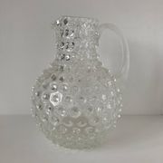 Beautiful and large vintage glass jug with a handle, made of clear hot-worked glass.