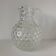 Beautiful and large vintage glass jug with a handle, made of clear hot-worked glass.