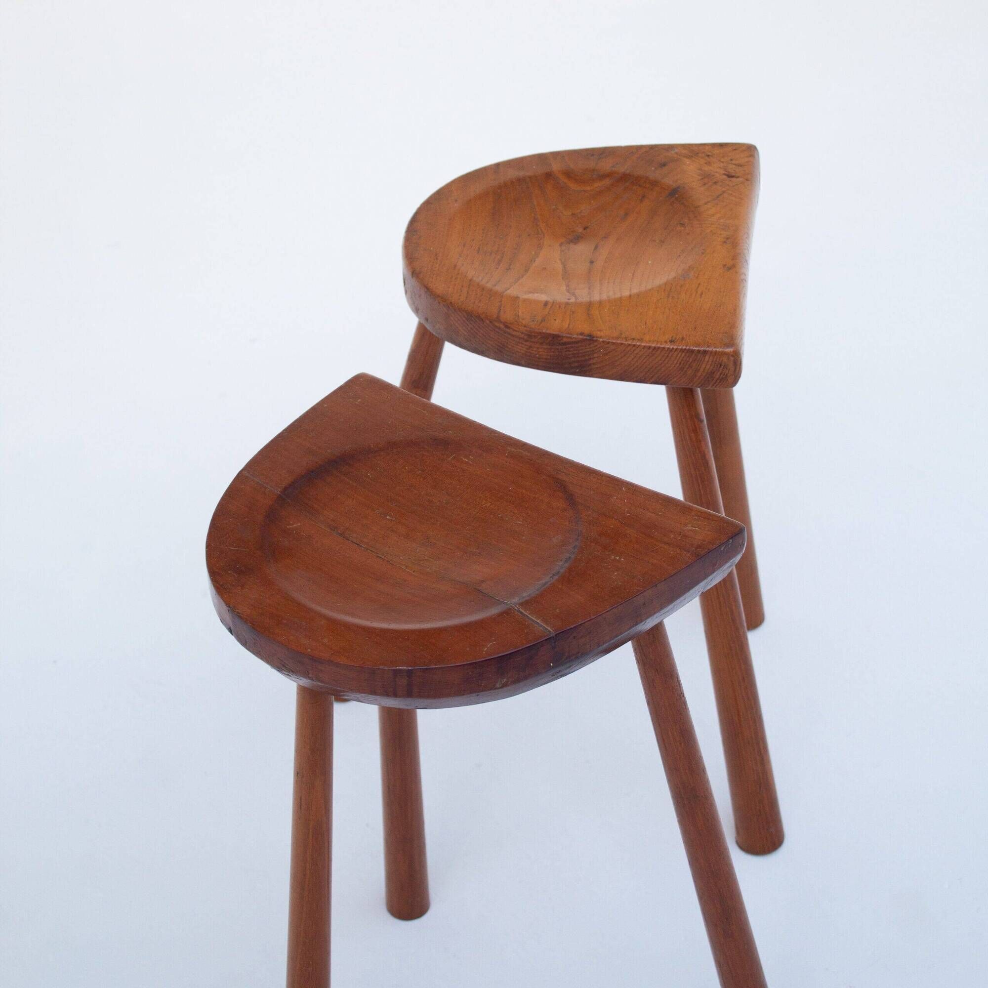 Set of two hand-carved wooden stools with sculpted seats