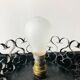 Handcrafted wrought iron lamp with a white opaline globe.