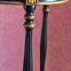 Tripod stool in blackened wood with painted floral decoration.
