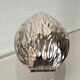 Nutcracker in the shape of a nut in silver-plated metal.