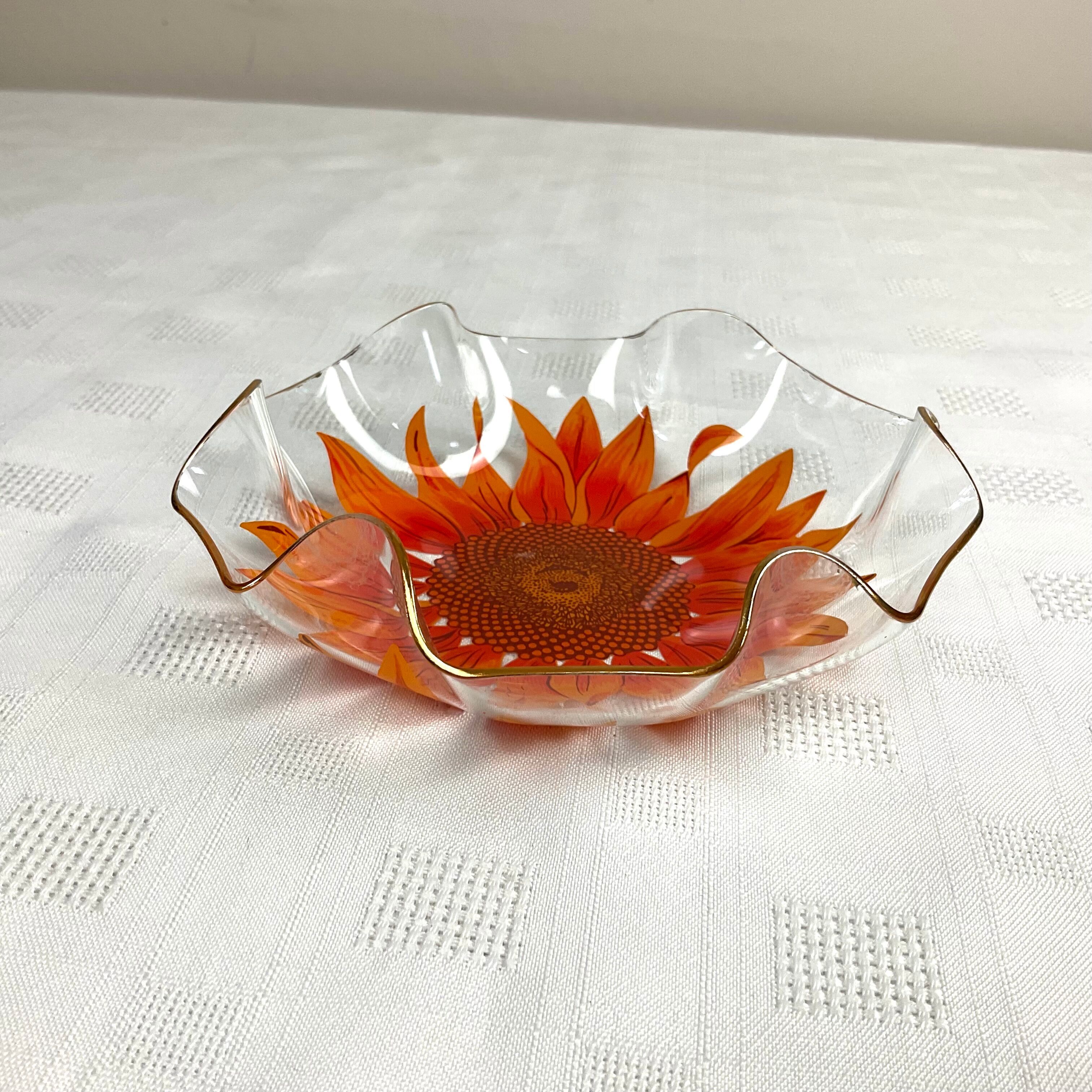 Glass cup with orange sunflower