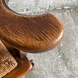 Brutalist dark brown solid wood armchair with natural rattan seat and cognac leather back