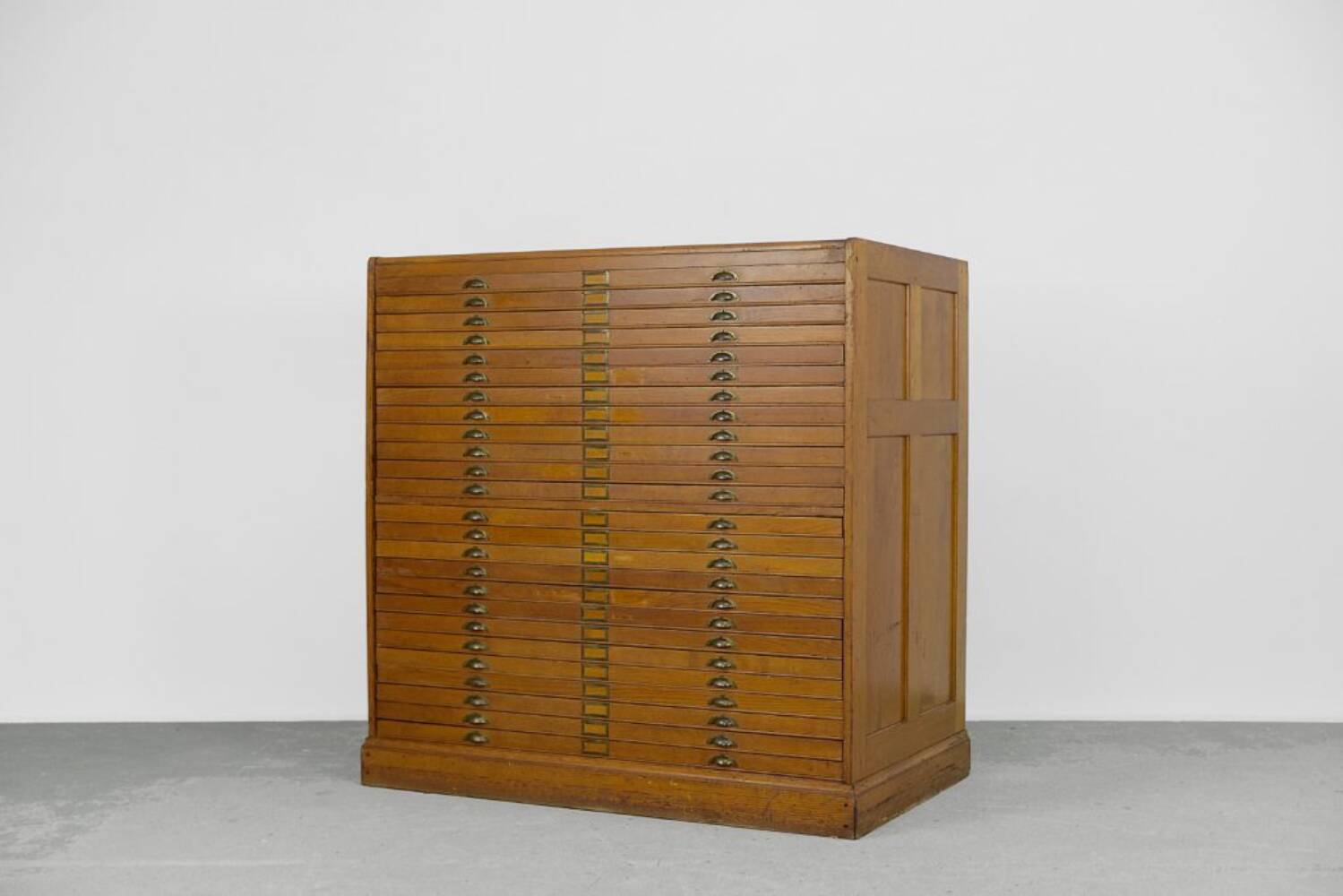 Vintage industrial oak filing cabinet with several drawers, 1930s.
