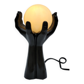 Resin hand lamp holding a vintage globe
