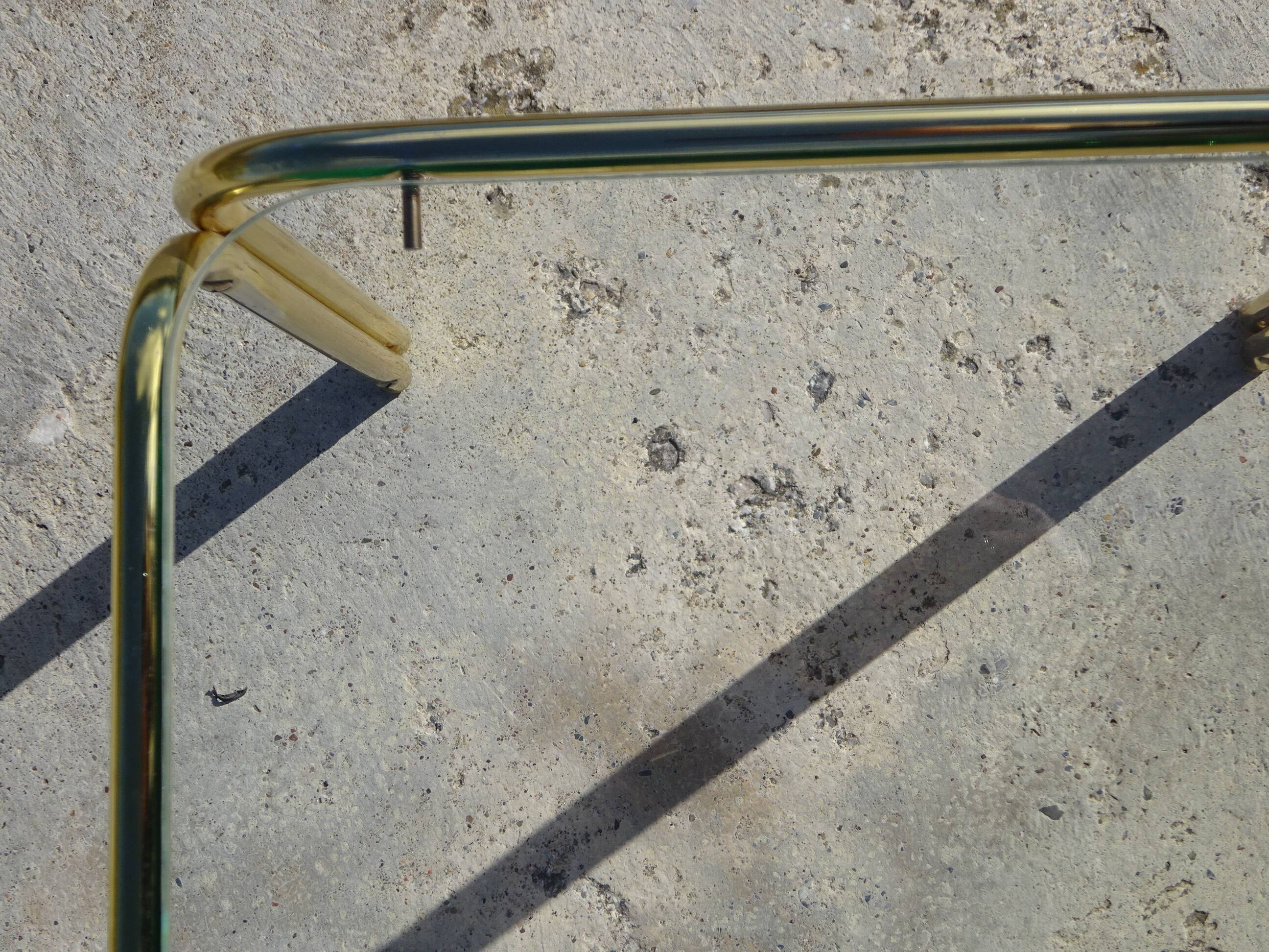 Nested tubular tables in gold metal.