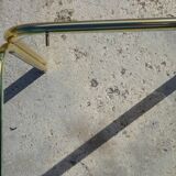 Nested tubular tables in gold metal.