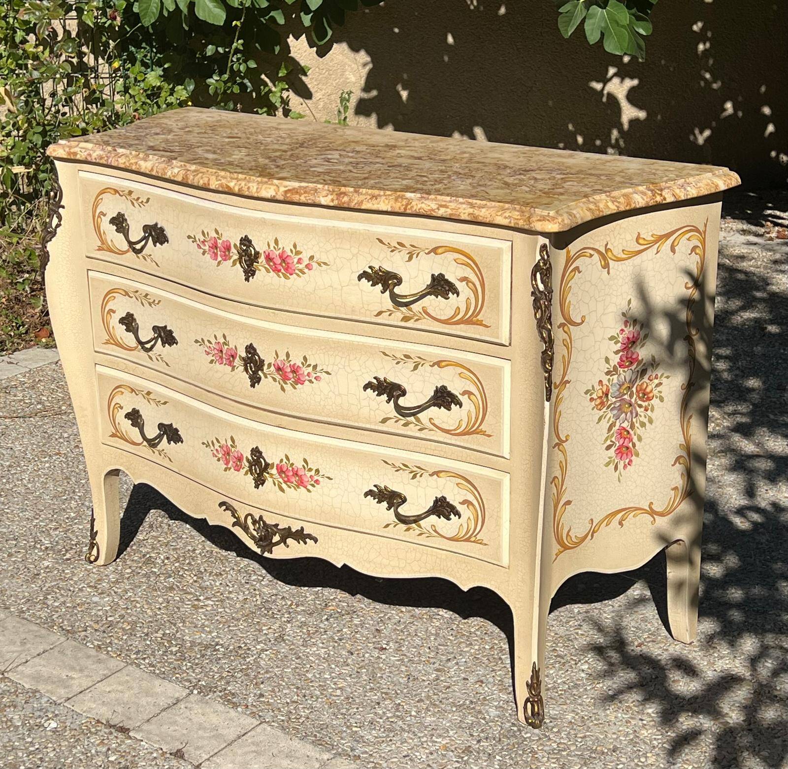 Curved Louis XV style commode in marble with painted floral decoration.