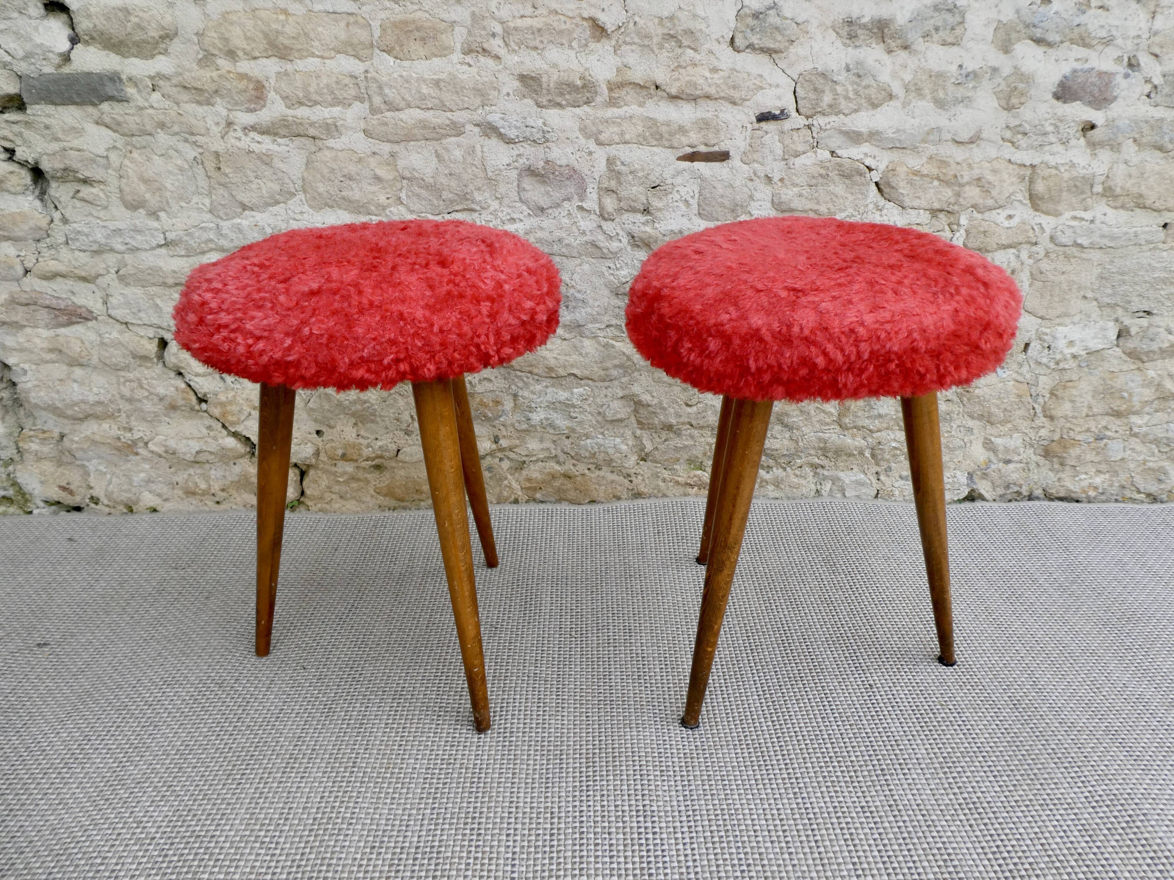 Pair of tripod stools, with tapered wooden feet and moumoute seat