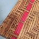 Sunbathing sunbathing in wicker rattan wood deckchair red lounger