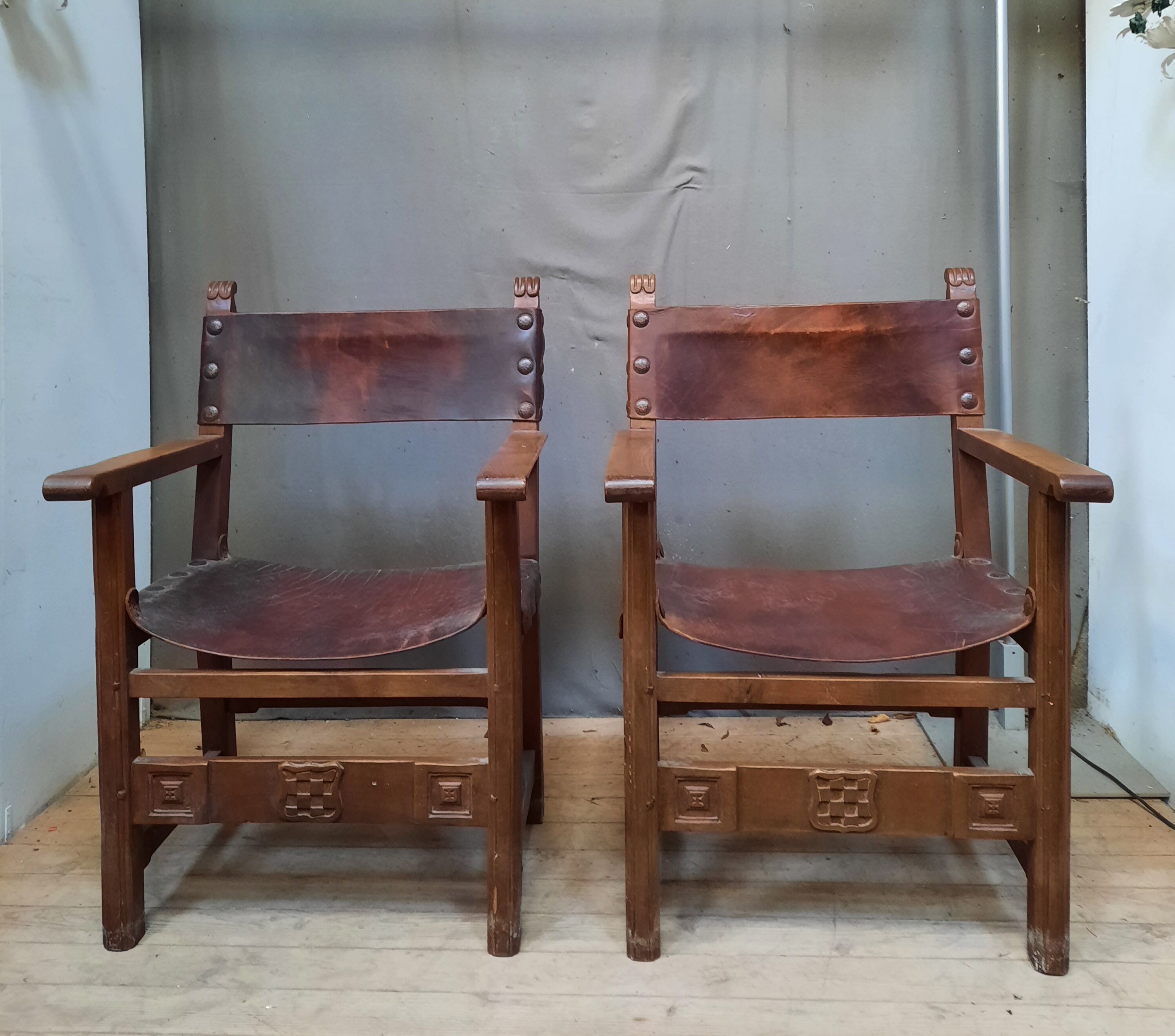 Pair of medieval leather style armchairs