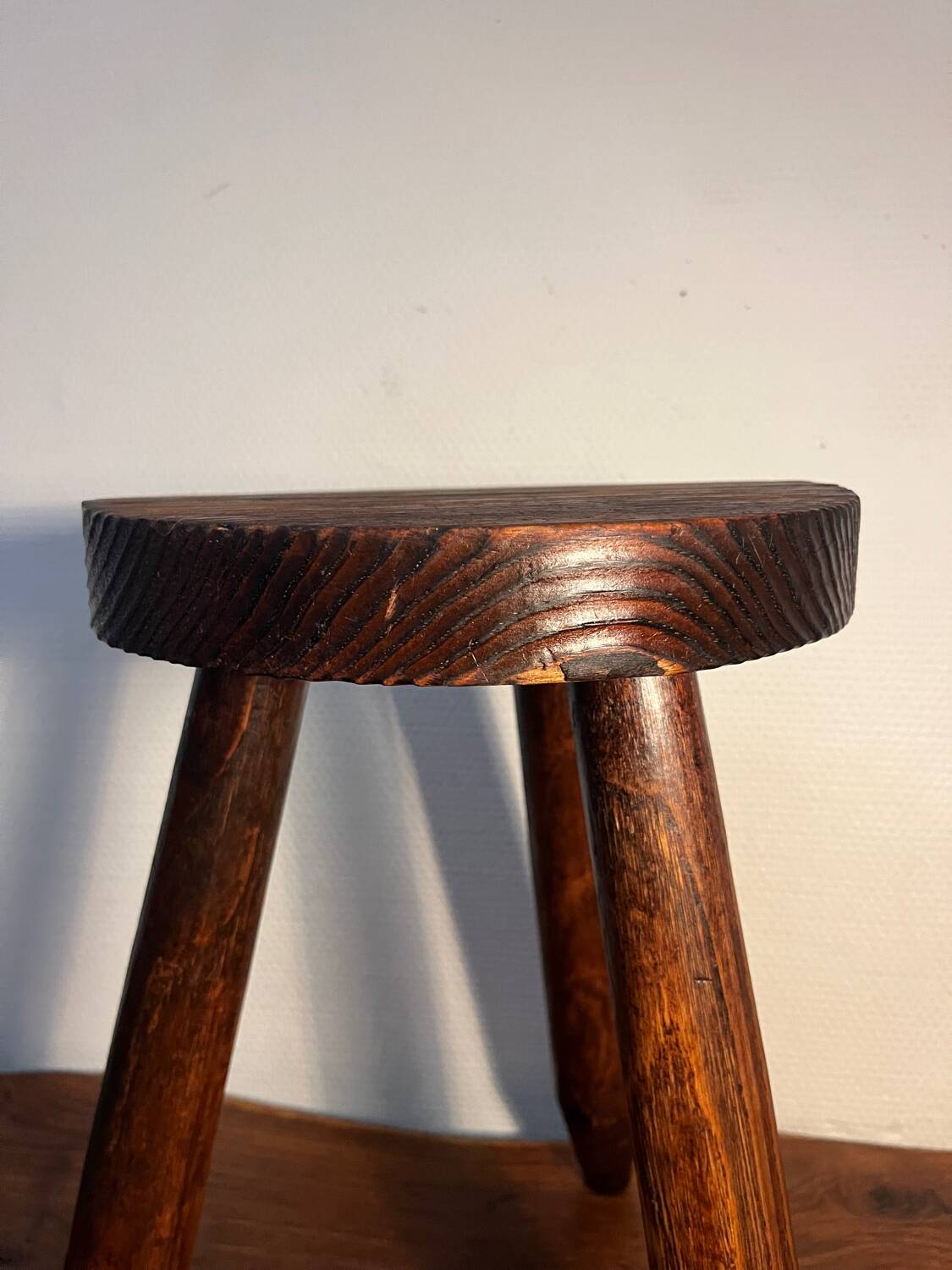 Round wooden tripod stool