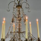 Golden bronze chandelier trimmed with drop-shaped grapevines