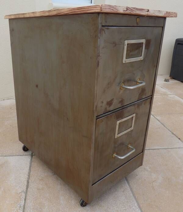 Vintage industrial metal furniture with a rusty effect, featuring two drawers on wheels.