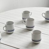 White ceramic cups with blue borders.