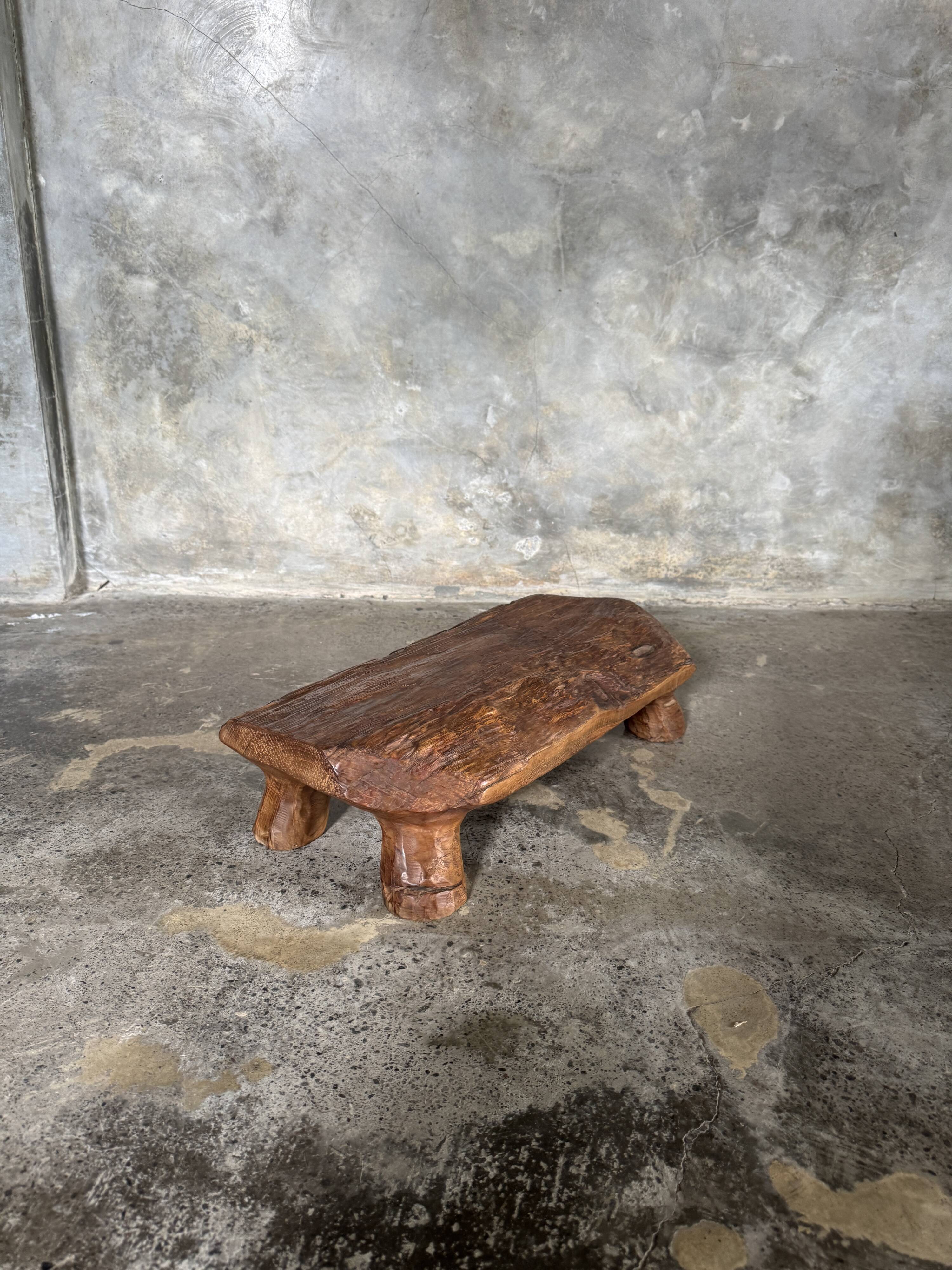 Small stool, footrest in blond teak, organic monoxyle with cut corners.