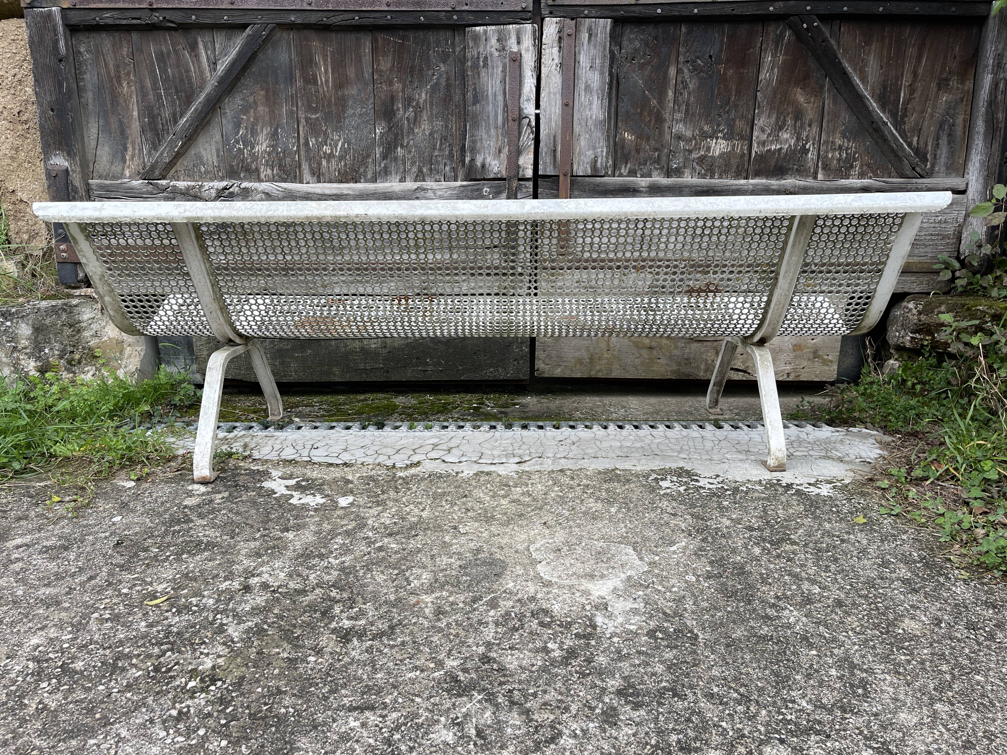 Old perforated metal garden bench