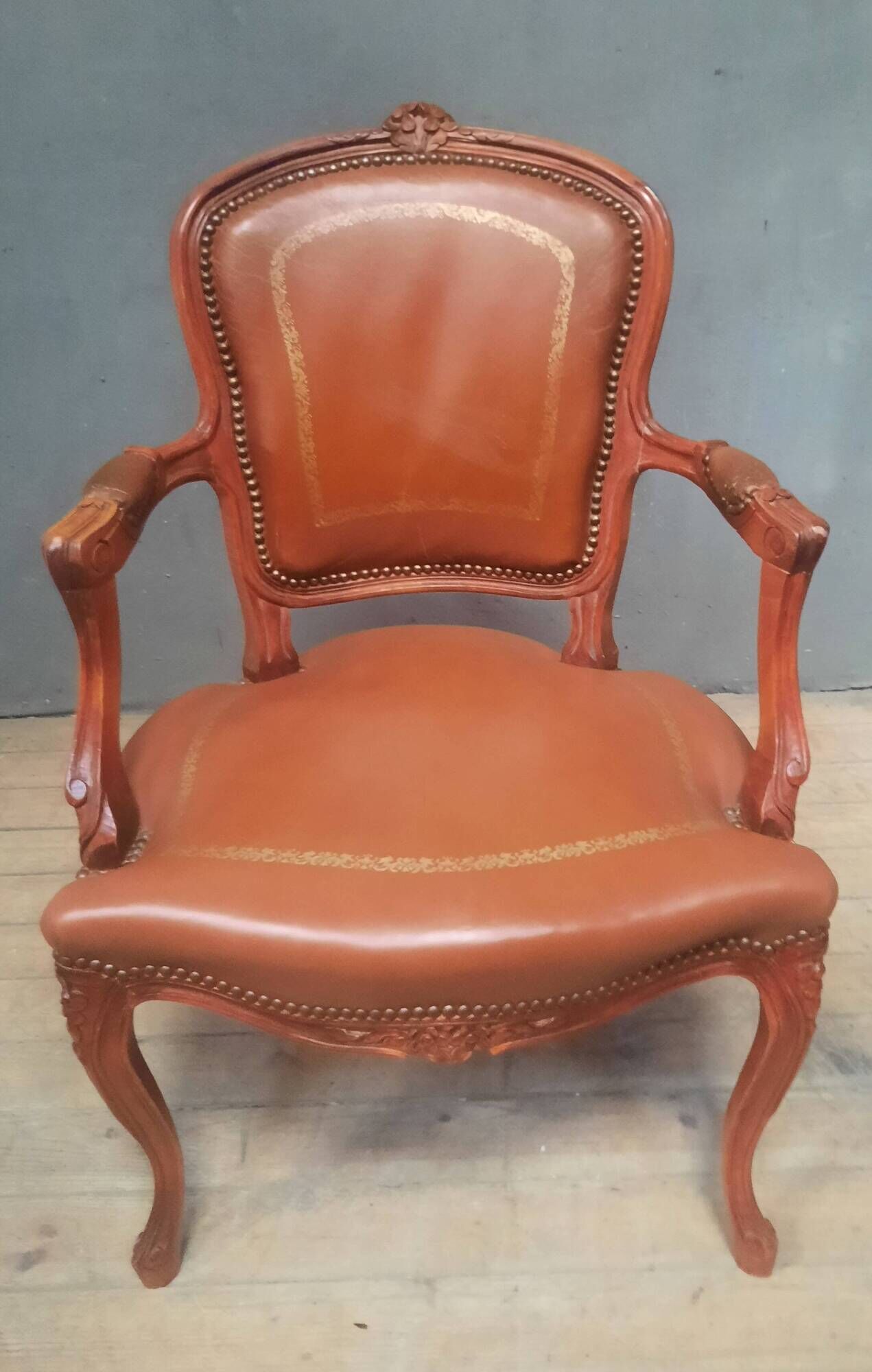 Louis XV style armchair covered in leather.