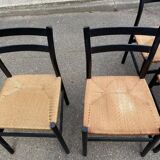 4 black Scandinavian chairs with solid wood and cord.