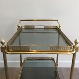 Neoclassical style rolling table in brass with blue glass tops